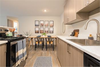 Modern kitchen with white countertops and dining nook